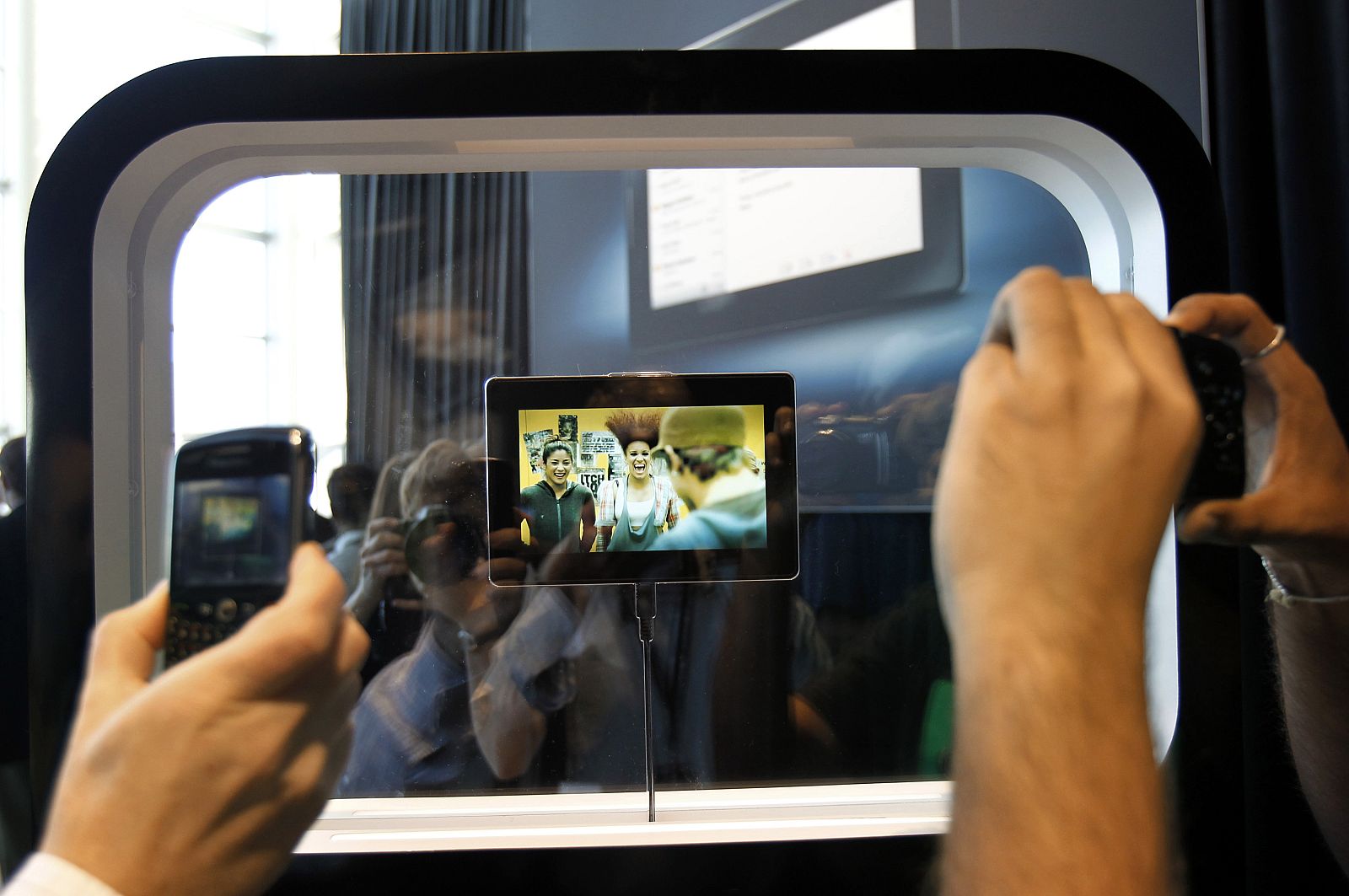 Conference attendees take photos of  the new Blackberry PlayBook at the Research in Motion Blackberry developers conference in San Francisco
