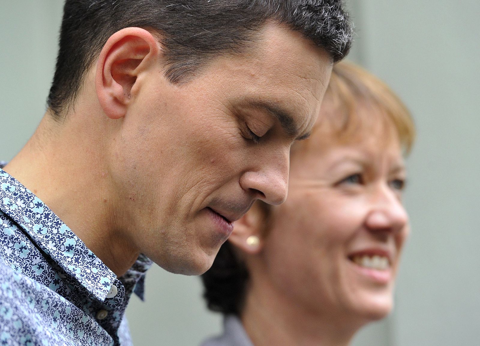Labour politician David Miliband poses for a photograph with his wife Louis Shackleton outside their home in central London