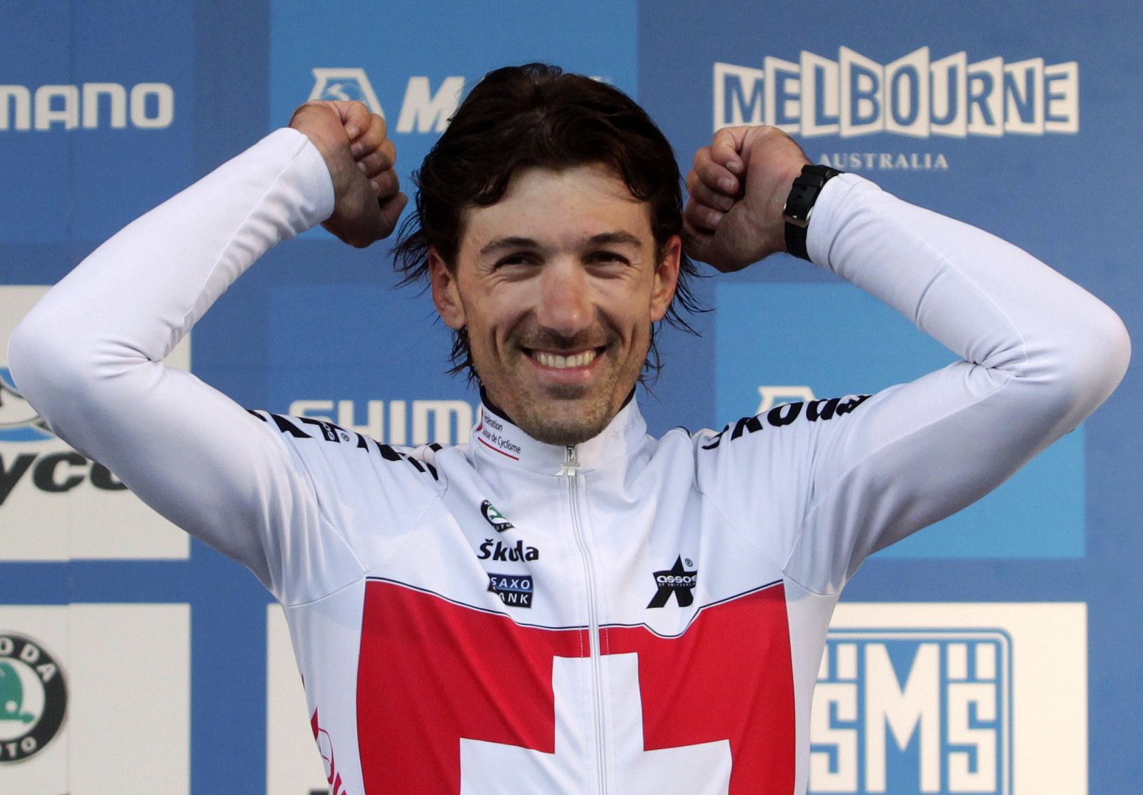 Switzerland's Cancellara celebrates on the podium after winning the gold medal in the elite men's time trial at the UCI Road Cycling World Championships in Geelong