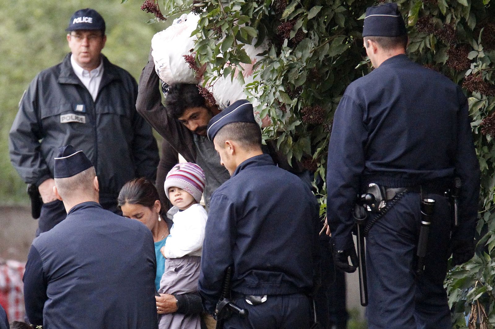 French police evacuate a Roma family from an illegal camp in Mons en Baroeul, near Lille