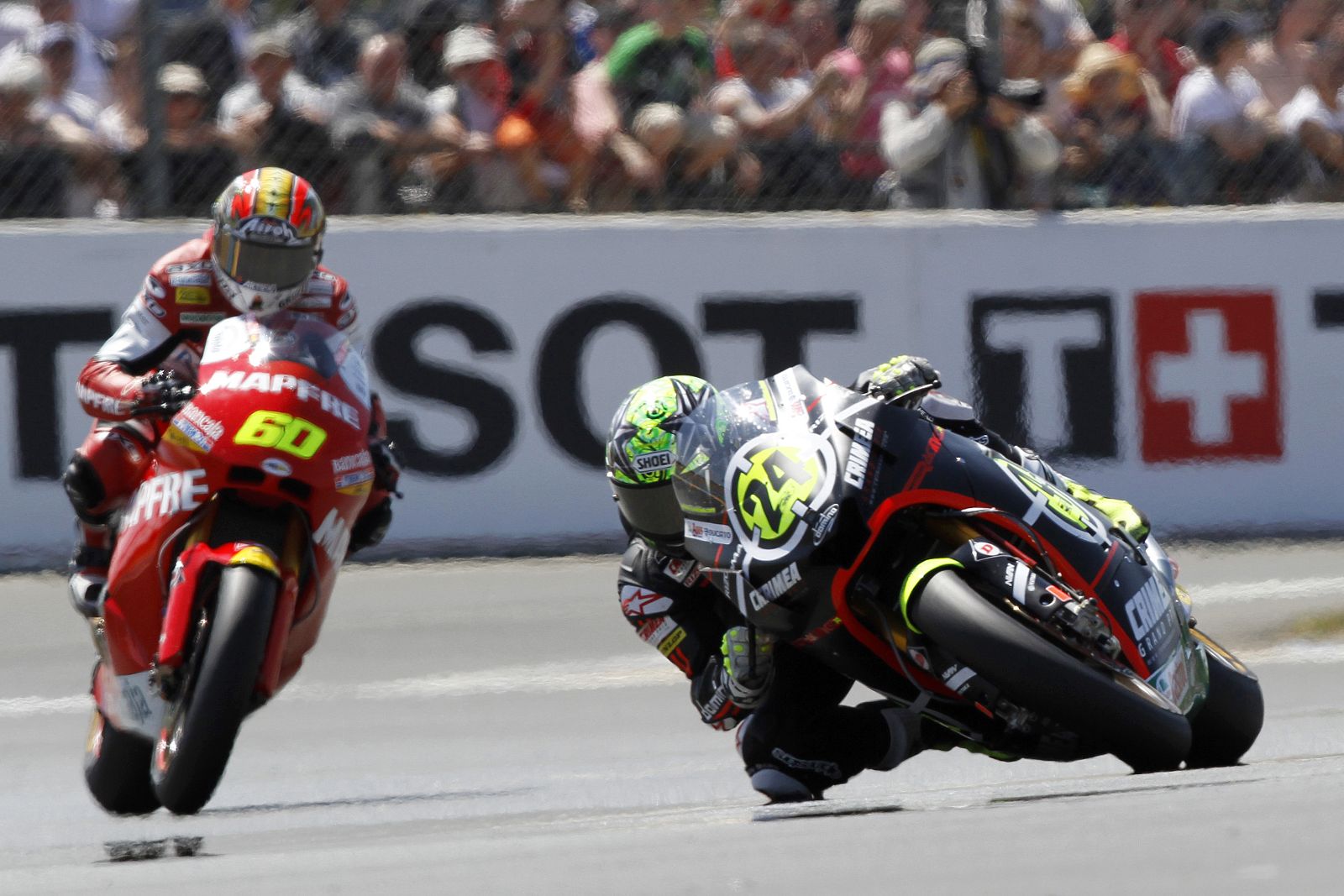 Moto2 rider Elias rides his Moriwaki ahead of Suter Moto2 rider Simon during the French motorcycling Grand Prix at Le Mans circuit