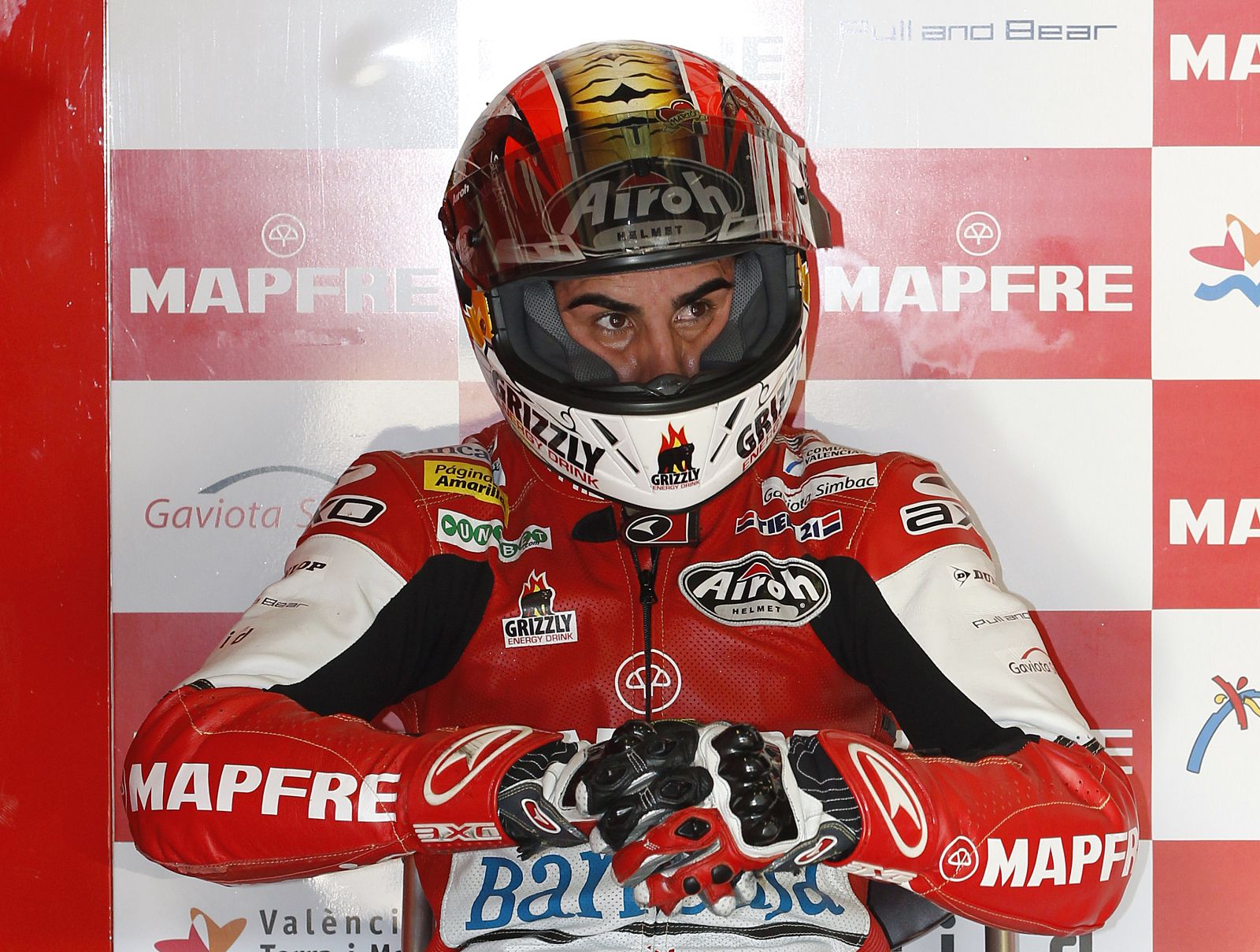 Suter Moto2 rider Julian Simon of Spain sits inside his pit garage during the qualifying session for the Japanese Grand Prix in Motegi