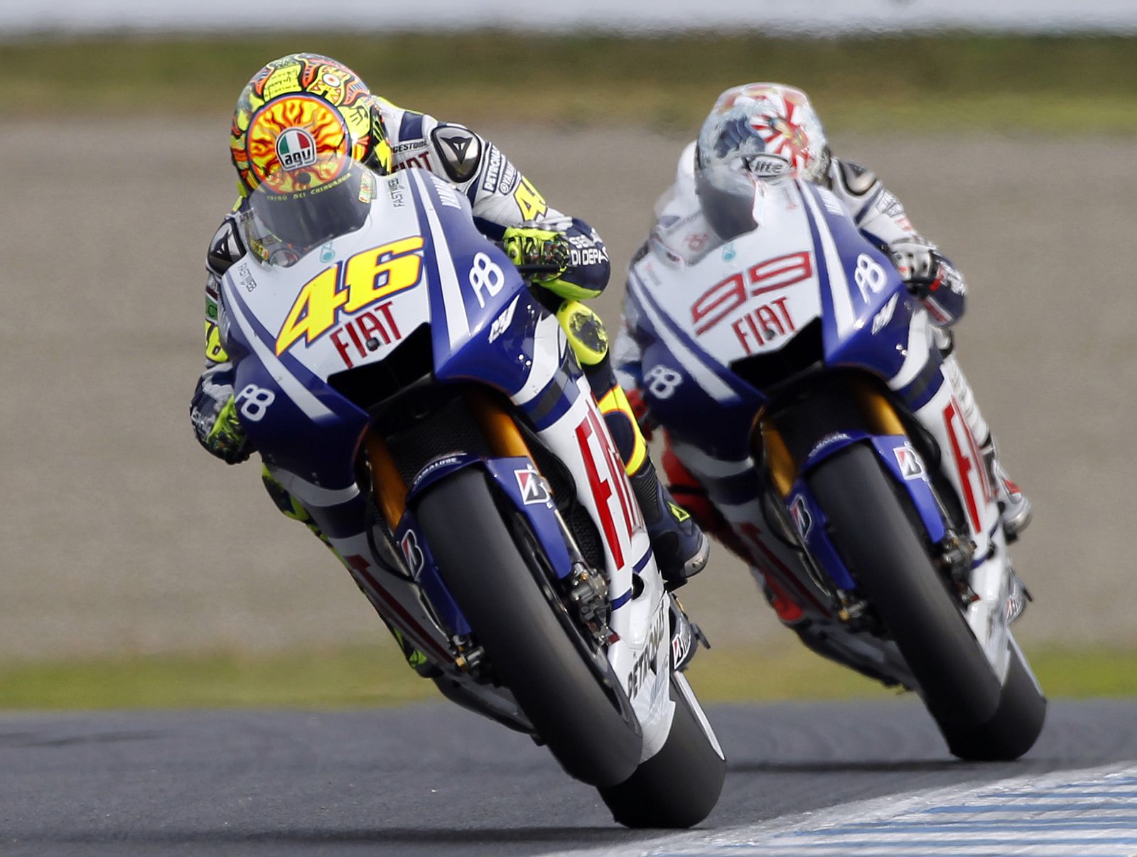 Yamaha MotoGP rider Valentino Rossi races ahead of his team-mate Jorge Lorenzo after they take the final corner during the Japanese Grand Prix in Motegi