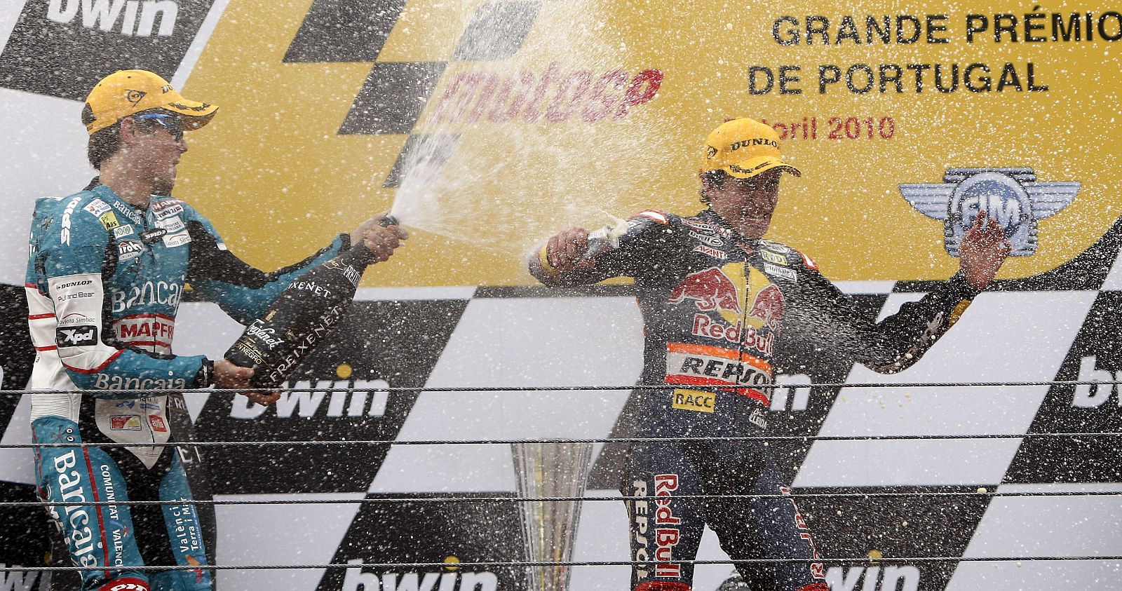 Derbi 125 cc rider Marquez of Spain and compatriot Terol celebrate on the podium their first and second places at the Portuguese Grand Prix