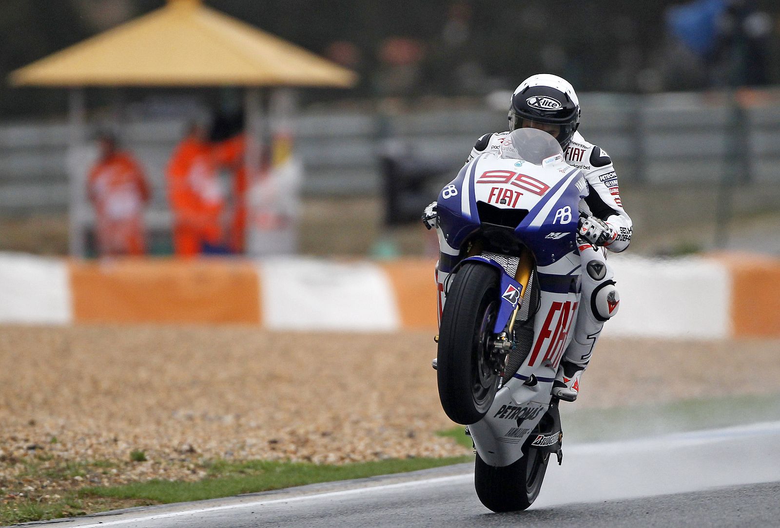 Yamaha MotoGP rider Jorge Lorenzo of Spain wheelies his motorcycle during the third free practice session for the Portuguese Grand Prix in Estoril