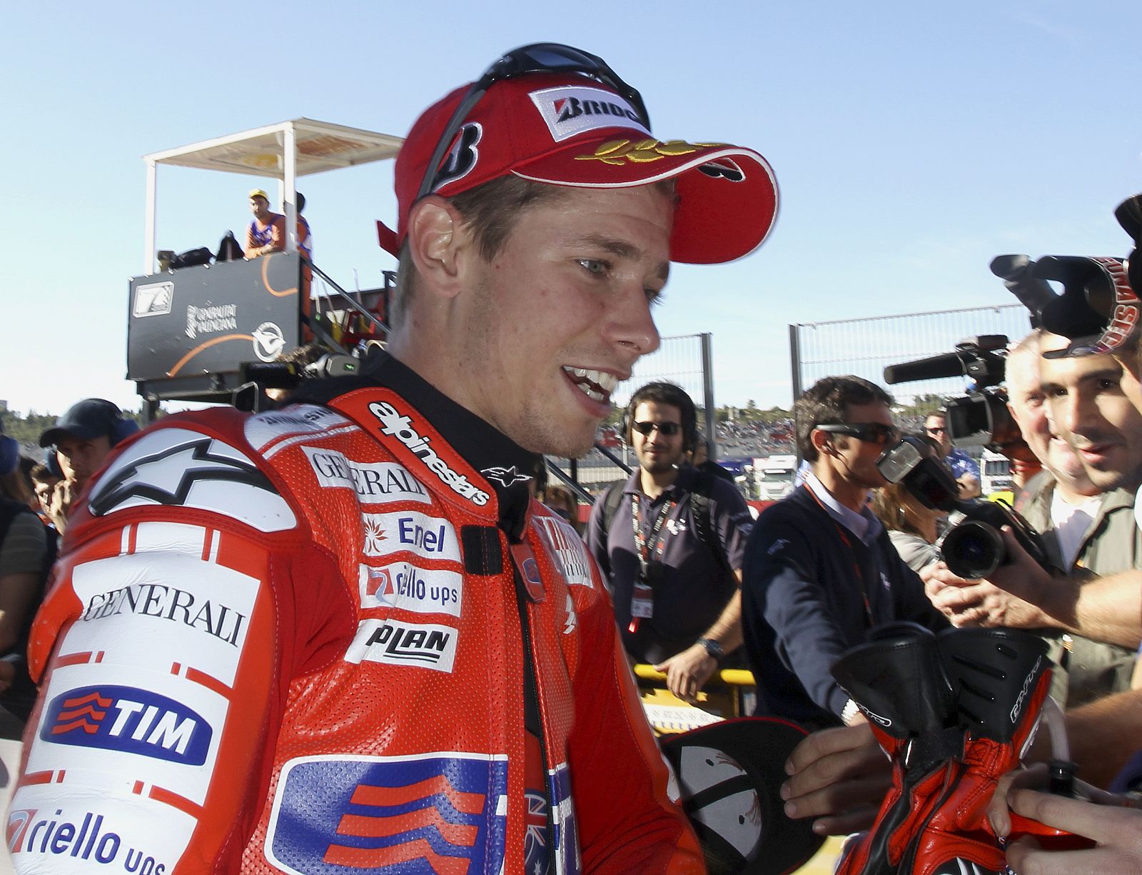 Ducati GP rider Casey Stoner of Australia smiles after taking the pole position in Valencia