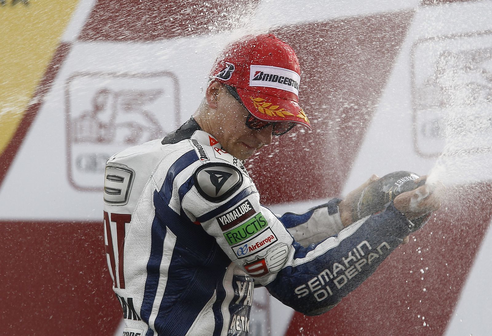 Yamaha MotoGP rider Lorenzo of Spain sprays champagne on the podium after winning the Valencia Motorcycle Grand Prix