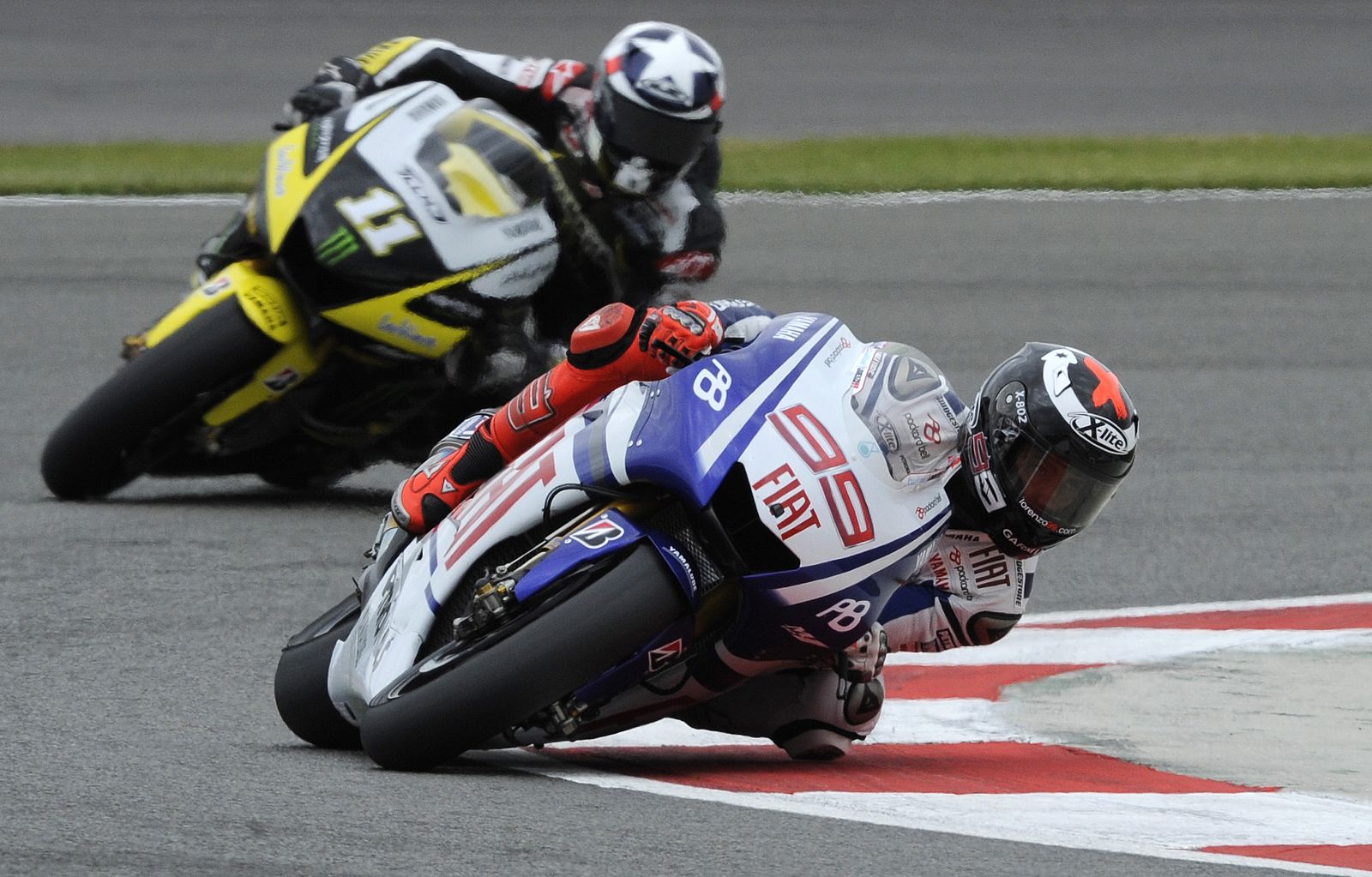Yamaha MotoGP rider Lorenzo takes a curve ahead of Monster Yamaha rider Spies during the qualifying session for the British Grand Prix at the Silverstone circuit