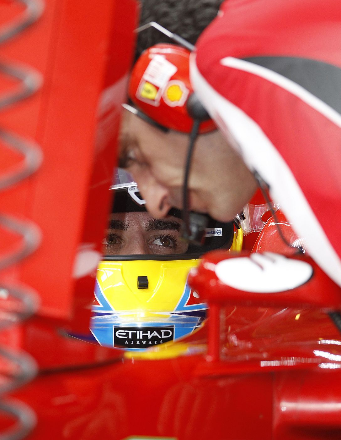Ferrari Formula One driver Fernando Alonso of Spain speaks to an engineer during the third practice session of the Abu Dhabi F1 Grand Prix