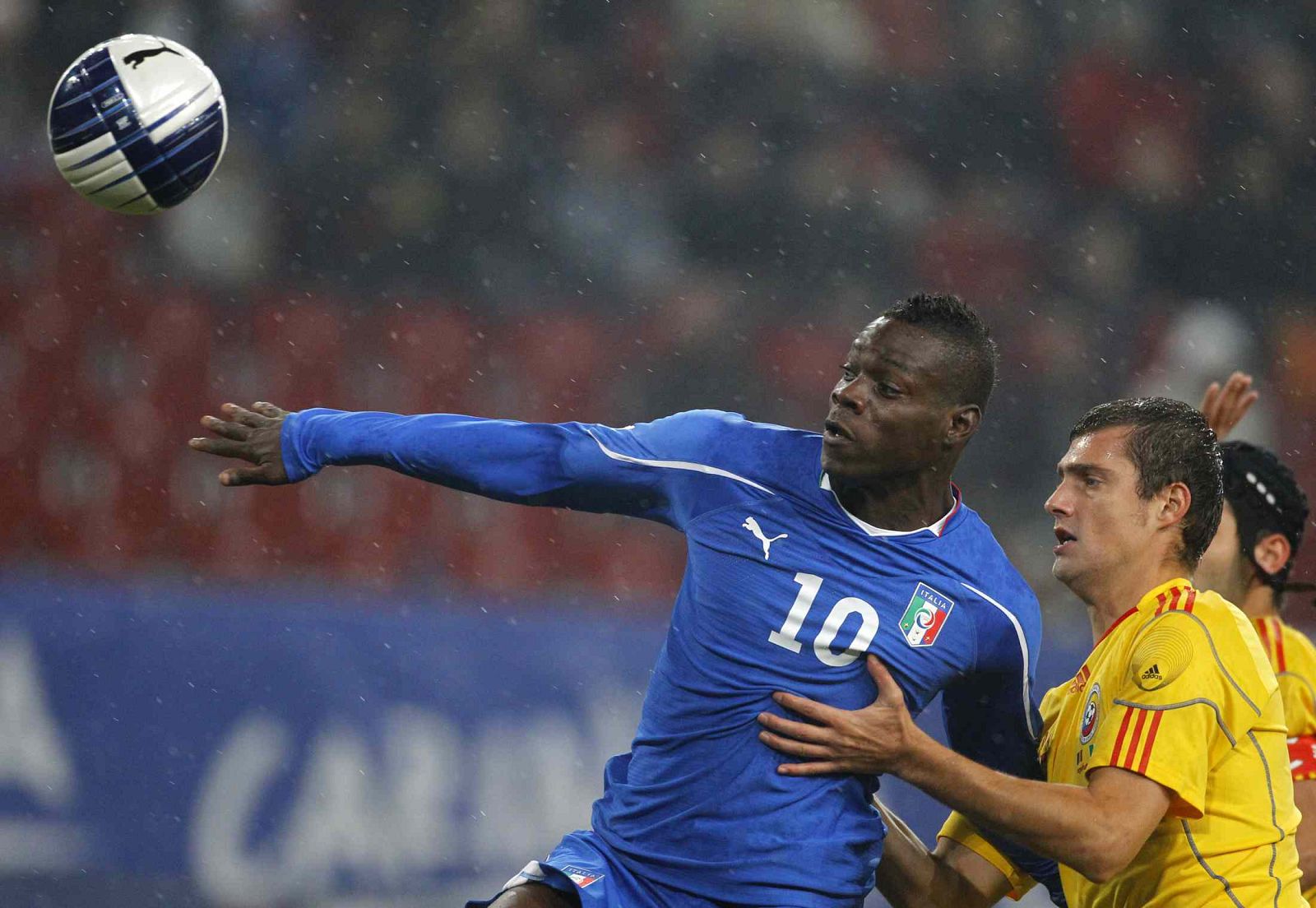Italy's Balotelli and Romania's Tamas fight for the ball during their friendly soccer match in Klagenfurt