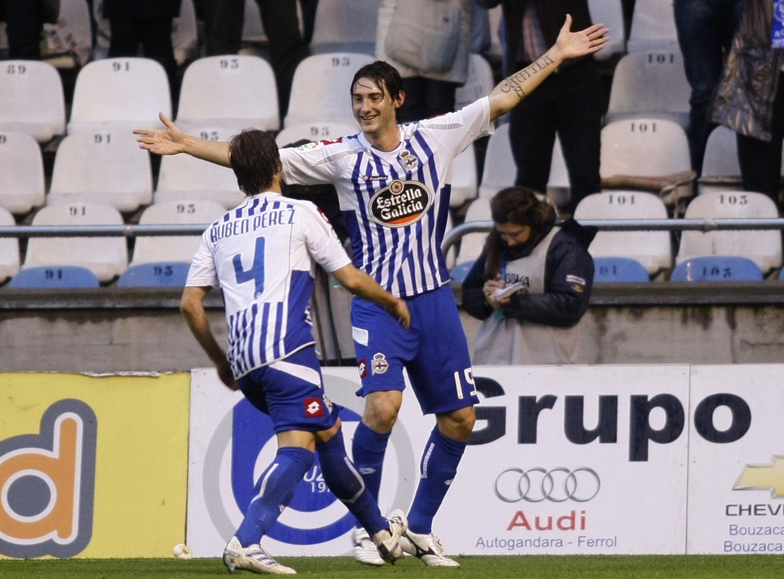 Deportivo Coruna's Diego Colotto celebrates his goal against Malaga with his teammate Ruben Perez during their Spanish First Division soccer match in Coruna