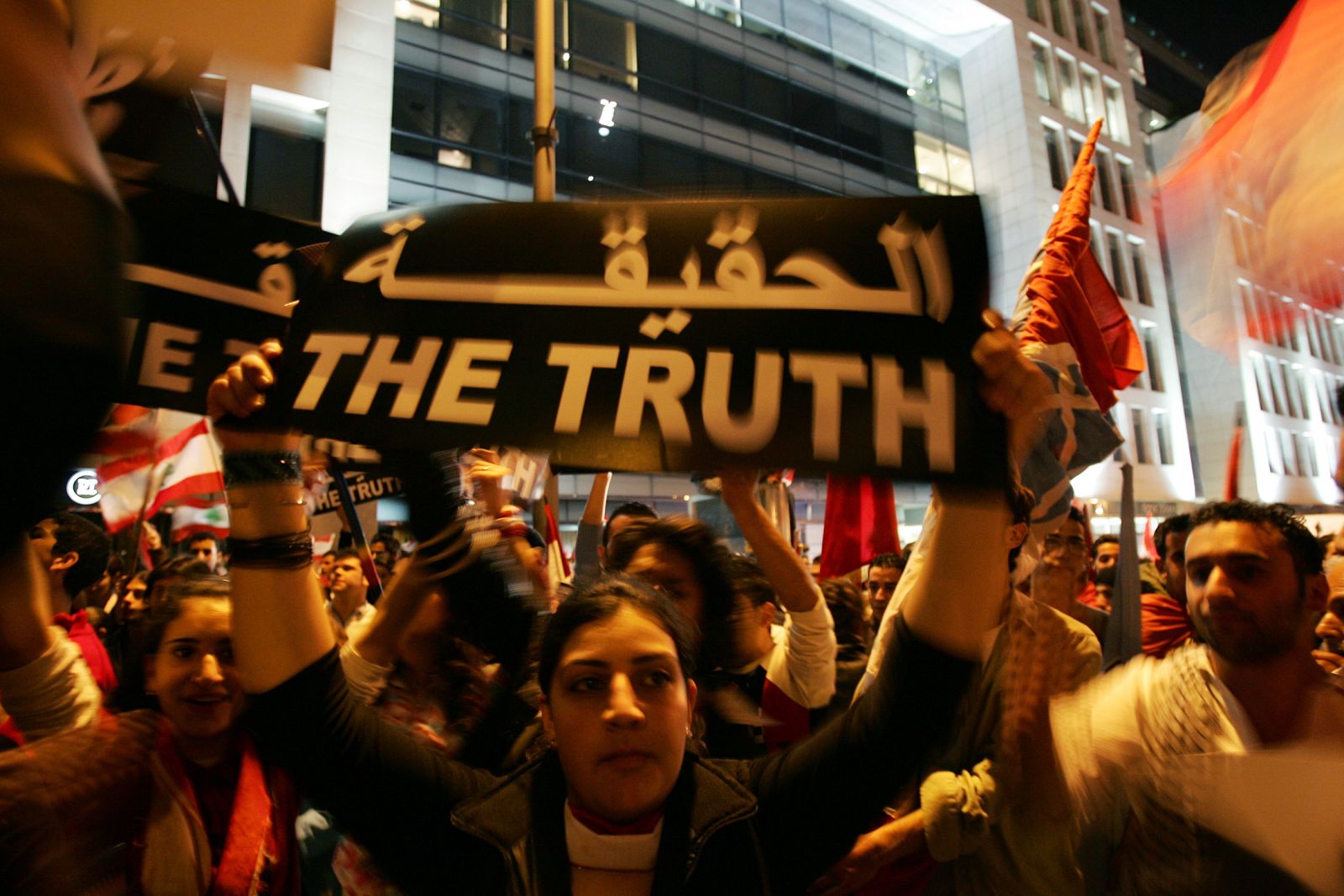 Lebanese students hold banners in front of the An-Nahar newspaper building in Beirut