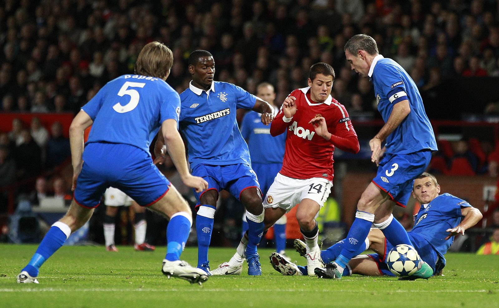 Manchester United's Hernandez runs through the Rangers defence during their Champions League Group C soccer match at Old Trafford in Manchester