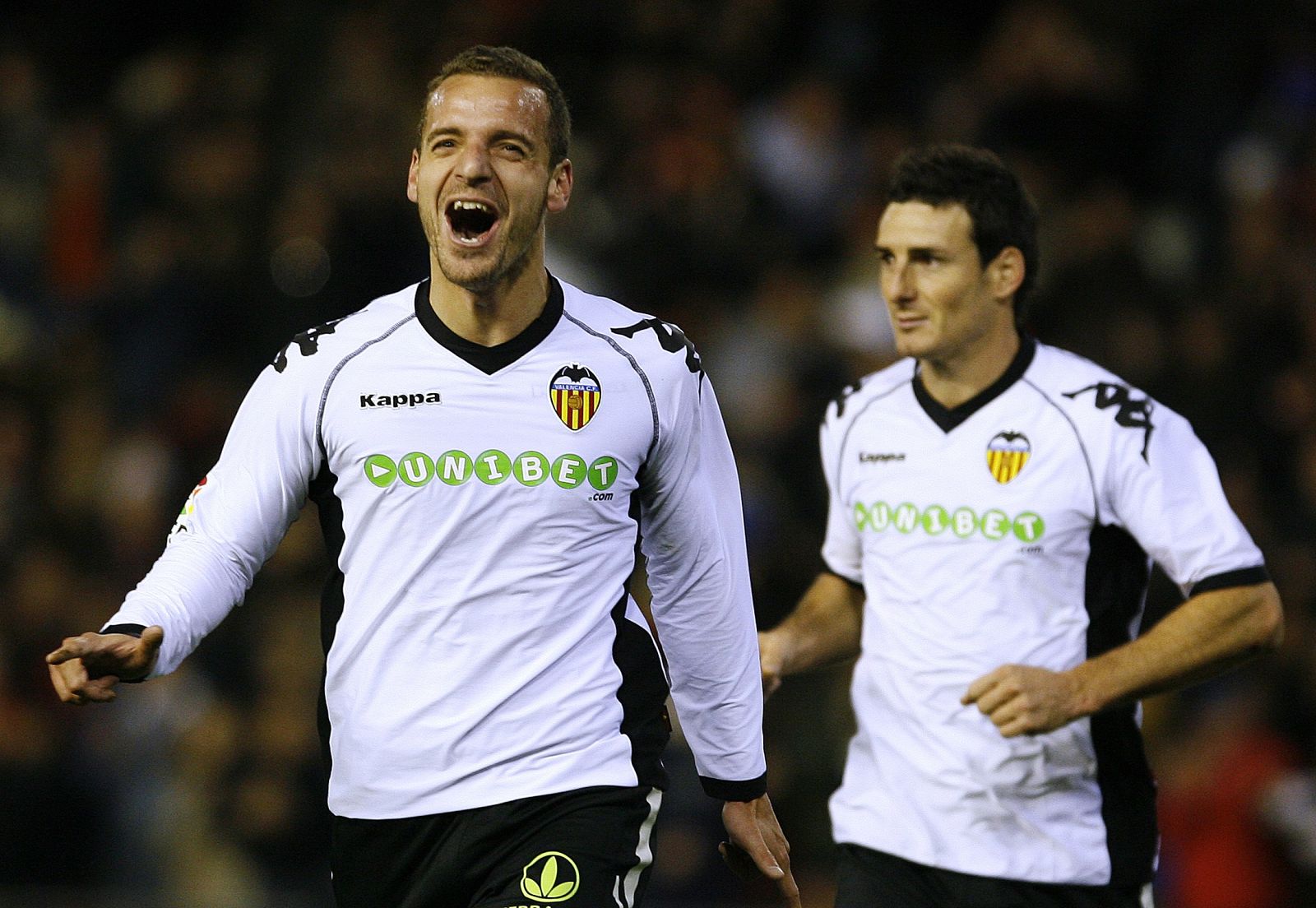 Valencia's Soldado celebrates with teammate Aduriz after scoring against Almeria during their Spanish first division soccer match in Valencia