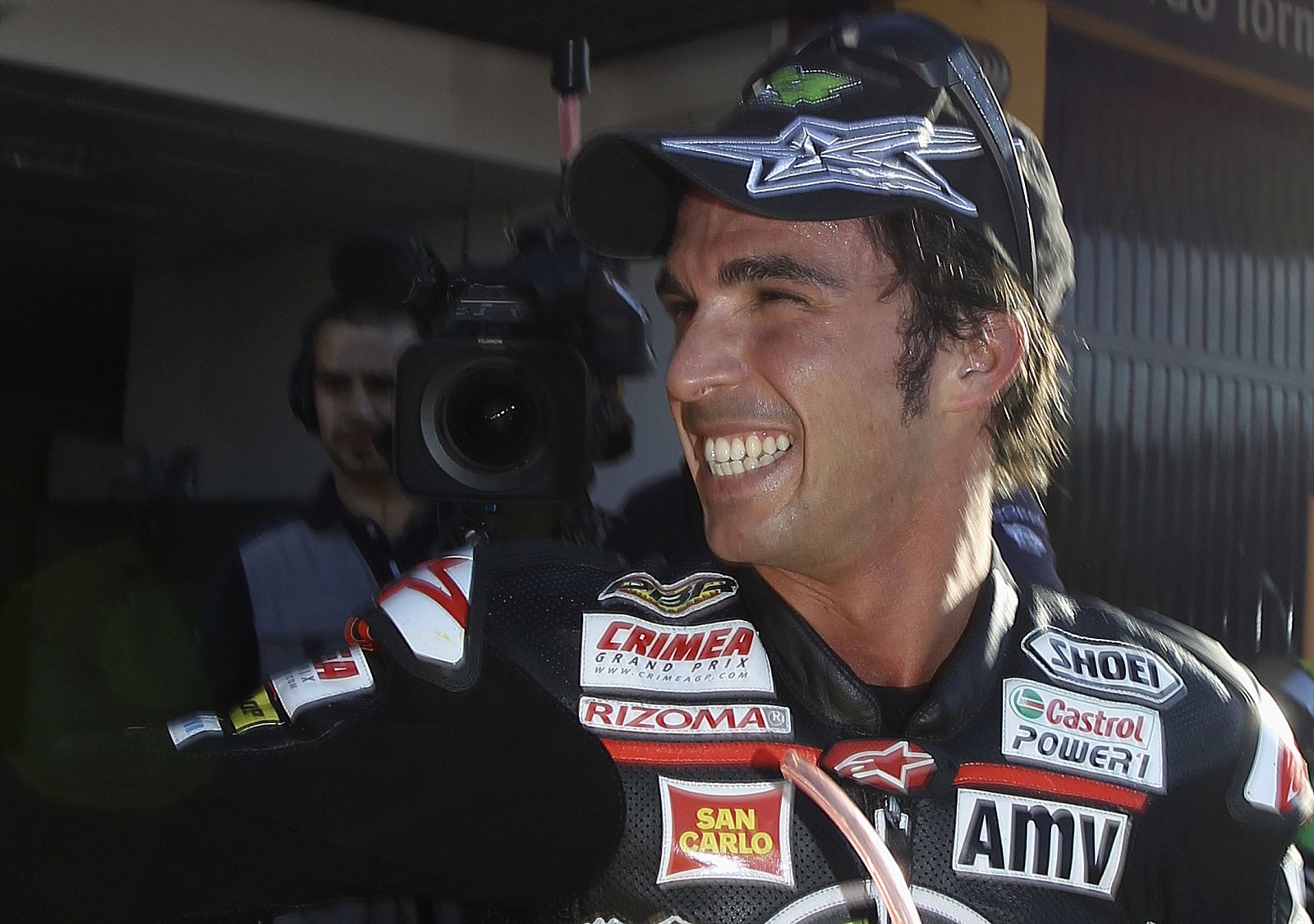 Moriwaki Moto2 rider Toni Elias of Spain celebrates after taking pole position in Valencia