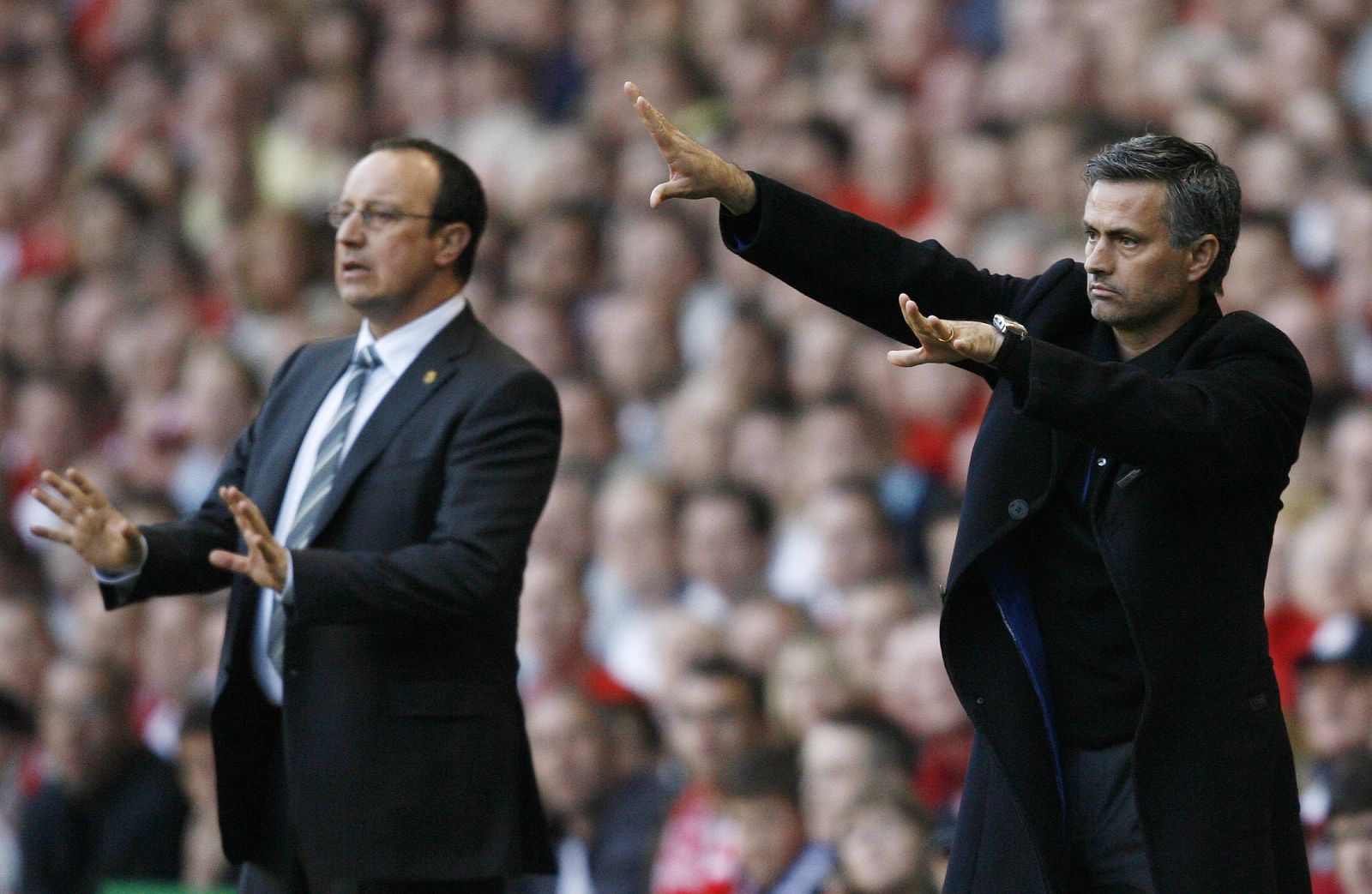 Chelsea's coach Mourinho gestures as Liverpool's coach Benitez looks on in Liverpool