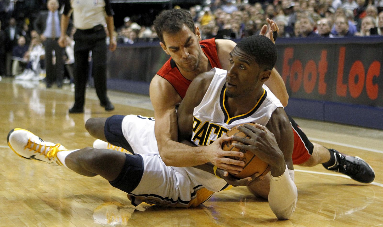 Pacers' Hibbert is challenged by Raptors' Calderon during their NBA basketball game in Indianapolis