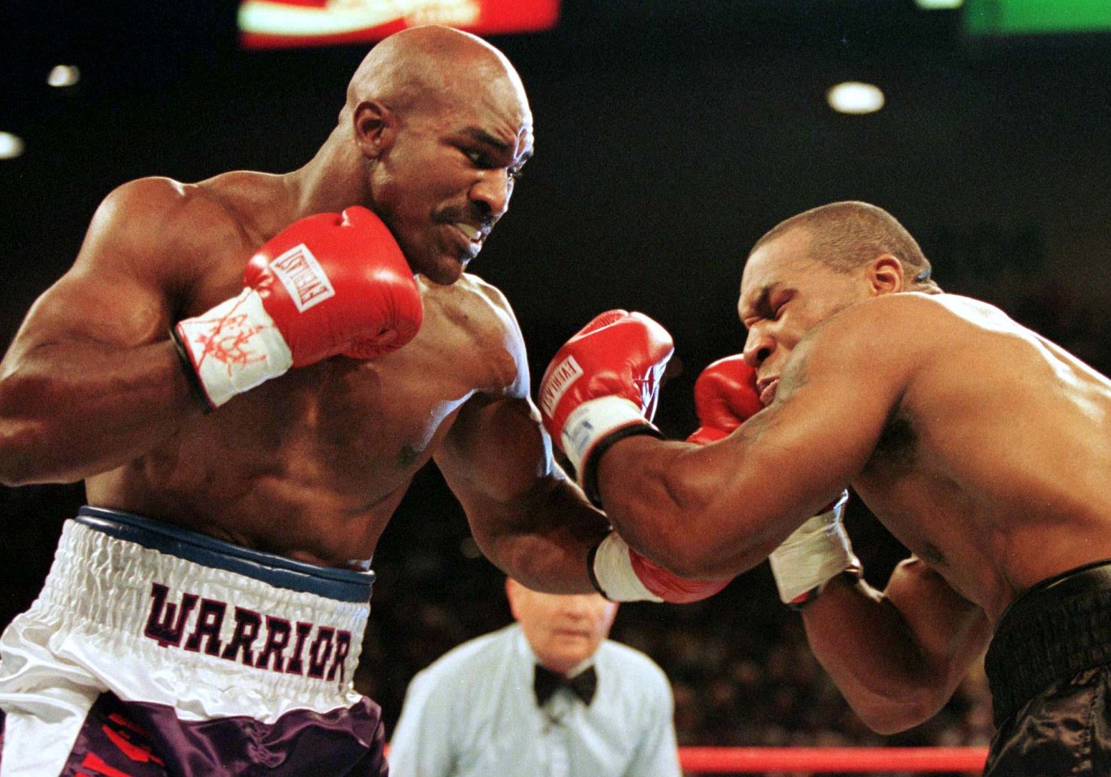 WBA Heavyweight Champion Evander Holyfield (R) connects to the jaw of challenger Mike Tyson in the f..