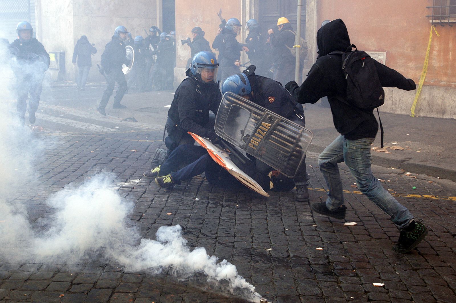Carabinieres block a demonstrator during anti government clashes near parliament in Rome