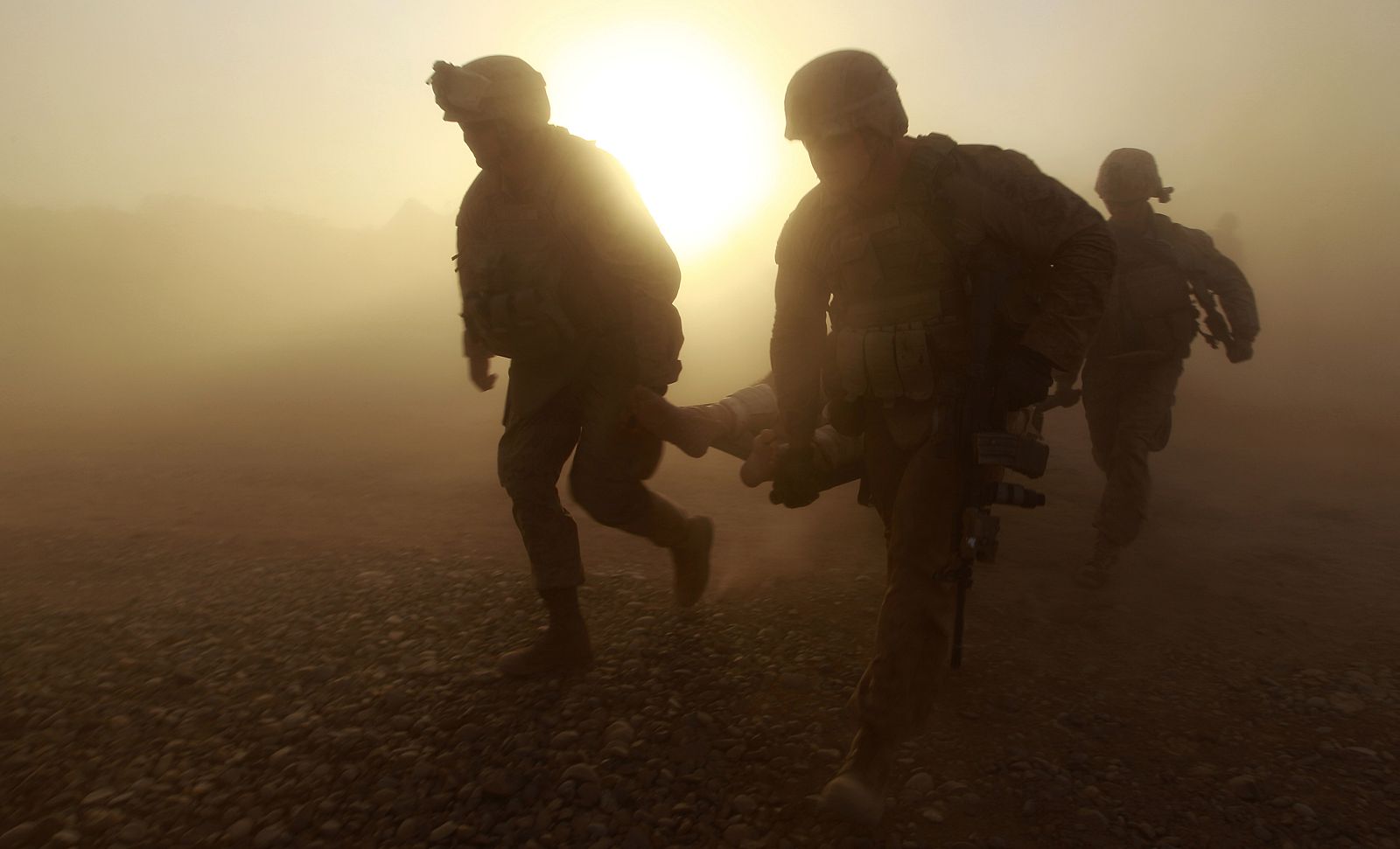 U.S. Marines help their wounded comrade to a helicopter during a Medevac mission in southern Afghanistan's Helmand Province