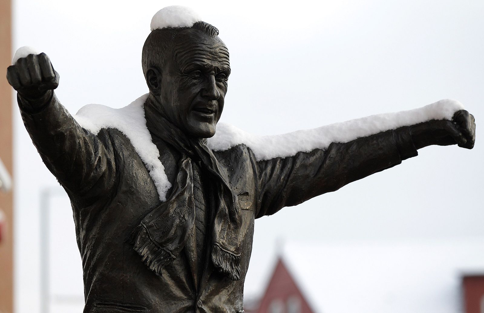 Snow covers a statue of legendary Liverpool manager Bill Shankly outside the club's Anfield stadium in Liverpool