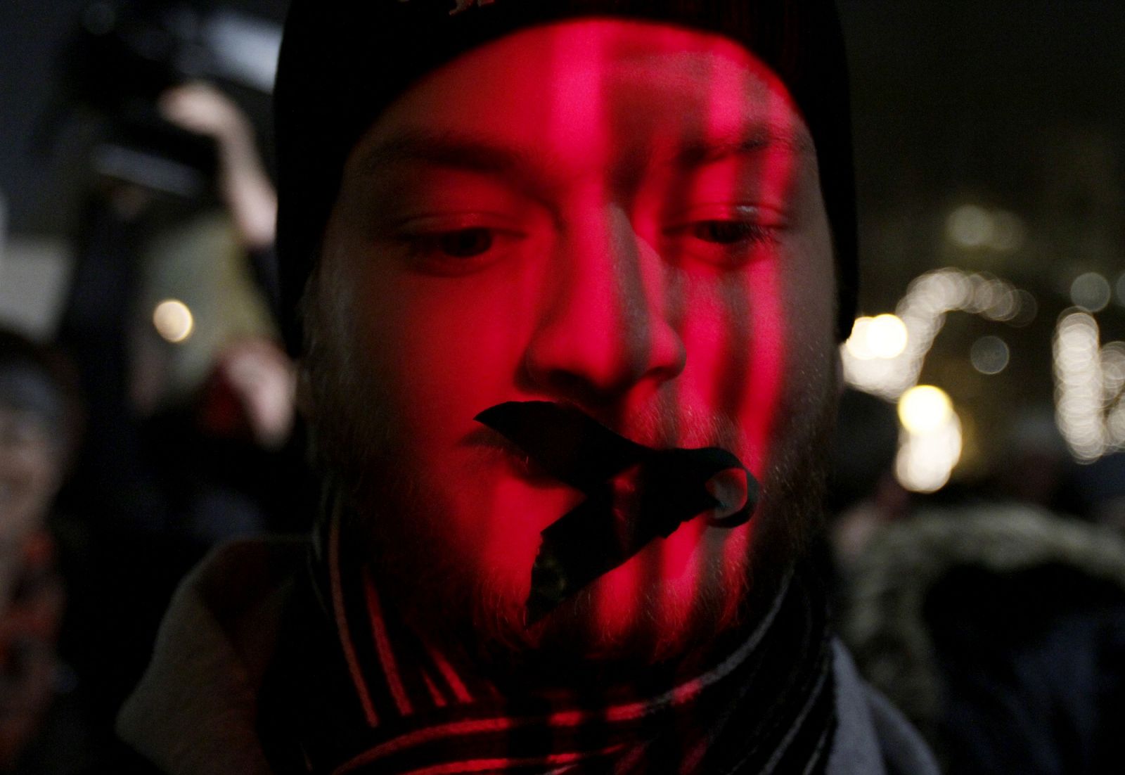 A protester wears tape over his mouth during a demonstration against a new media law in downtown Budapest