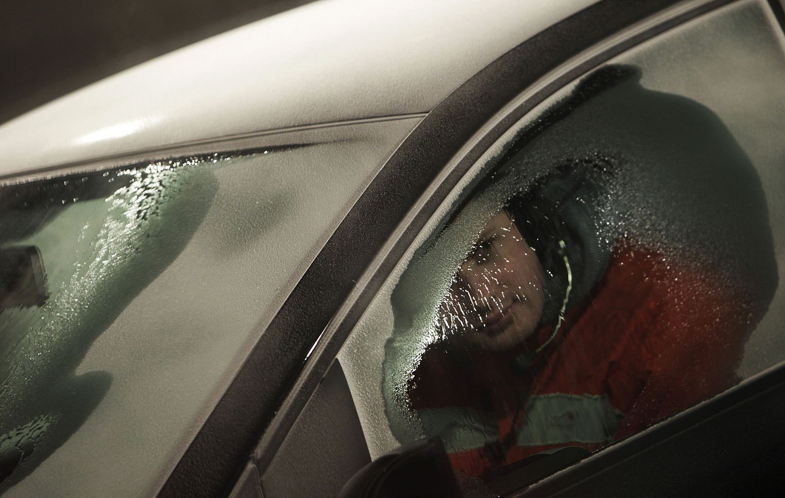 A technician peers out from a window of a Volkswagen car in a test room with low temperature to test the defrosting of the windows in the Skoda Auto Technological Center in Mlada Boleslav
