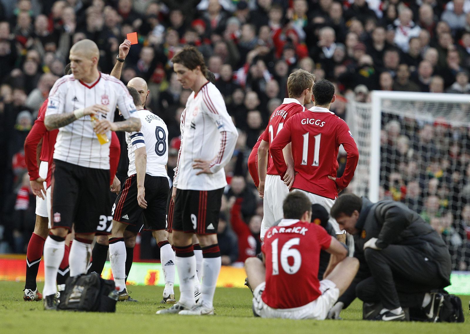 Liverpool's Gerrard is sent off as Manchester United's Carrick is attended to during their FA Cup soccer match at Old Trafford in Manchester, northern England