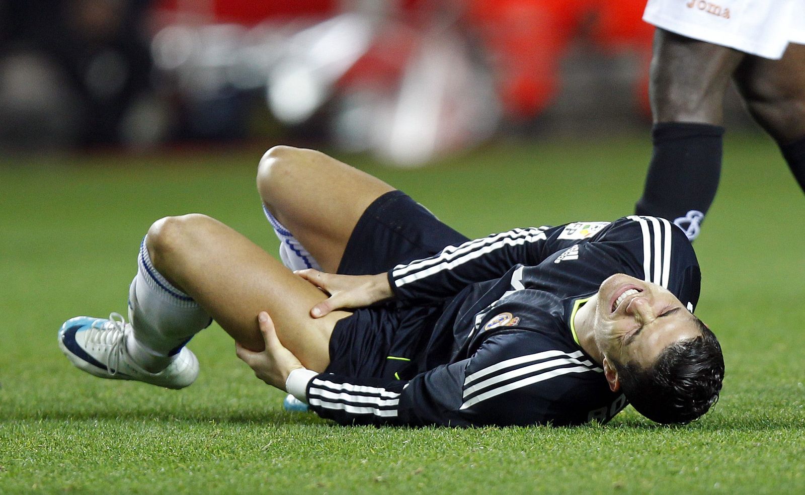 Real Madrid's Ronaldo grimaces in pain after a tackle during their Spanish King's Cup semi-final soccer match against Sevilla in Seville