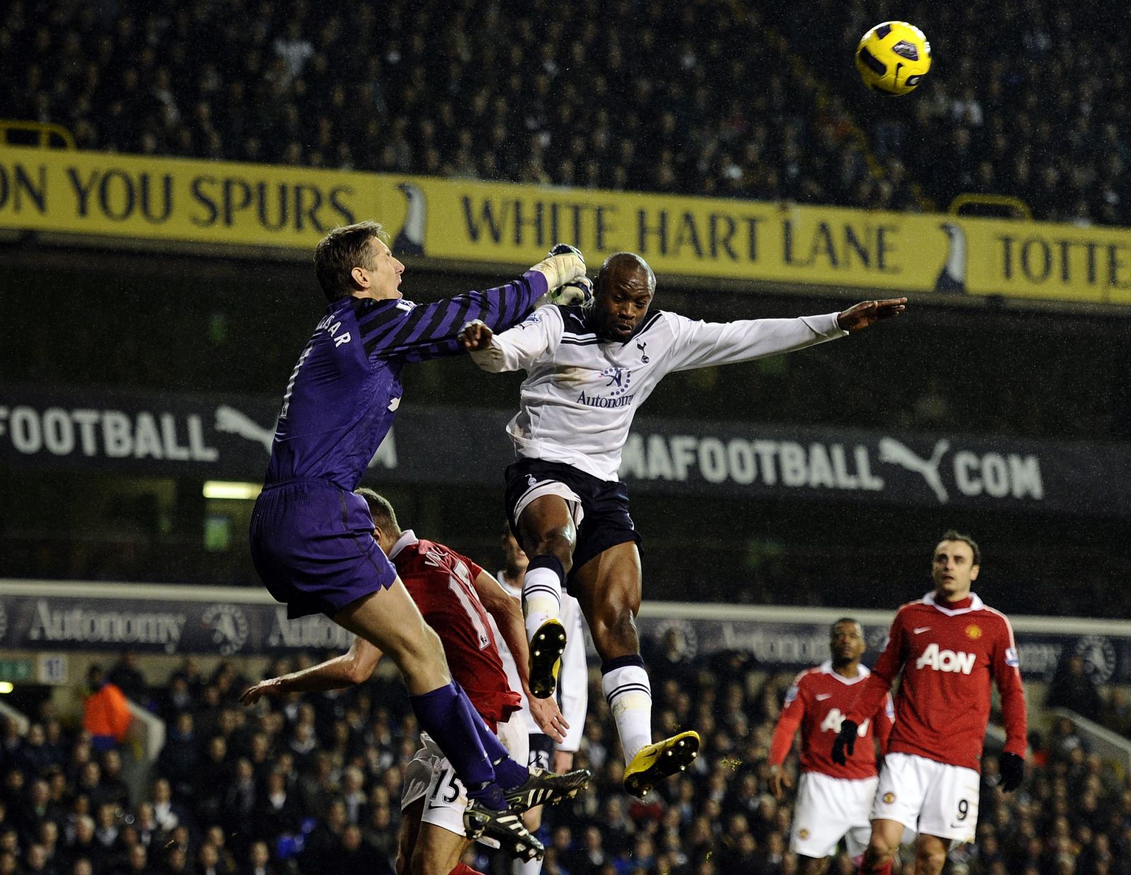 Edwin Van Der Sar of Manchester United punches the ball away as William Gallas of Tottenham Hotspur jumps during their English Premier League soccer match at White Hart Lane, London