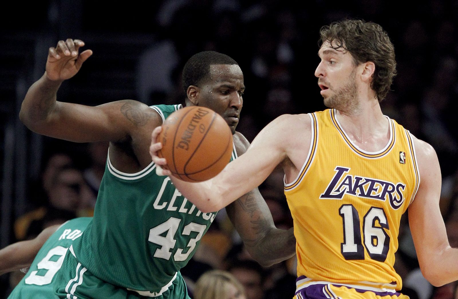 Los Angeles Lakers forward Gasol takes the ball inside of Boston Celtics center Perkins in the second half of their NBA basketball game in Los Angeles