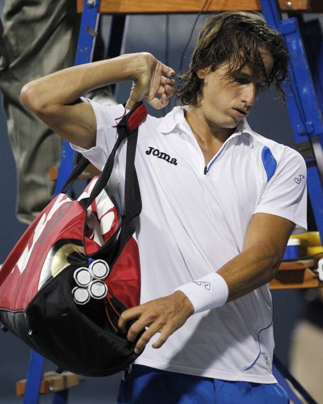 Lopez collects his belongings after losing to Murray in their semi-final match at the ATP L.A. Tennis Open tournament in Los Angeles
