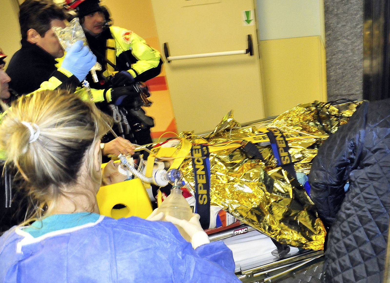 Rescue workers carry Formula One driver Kubica of Poland following an accident in a rally car during a minor rally near Genoa
