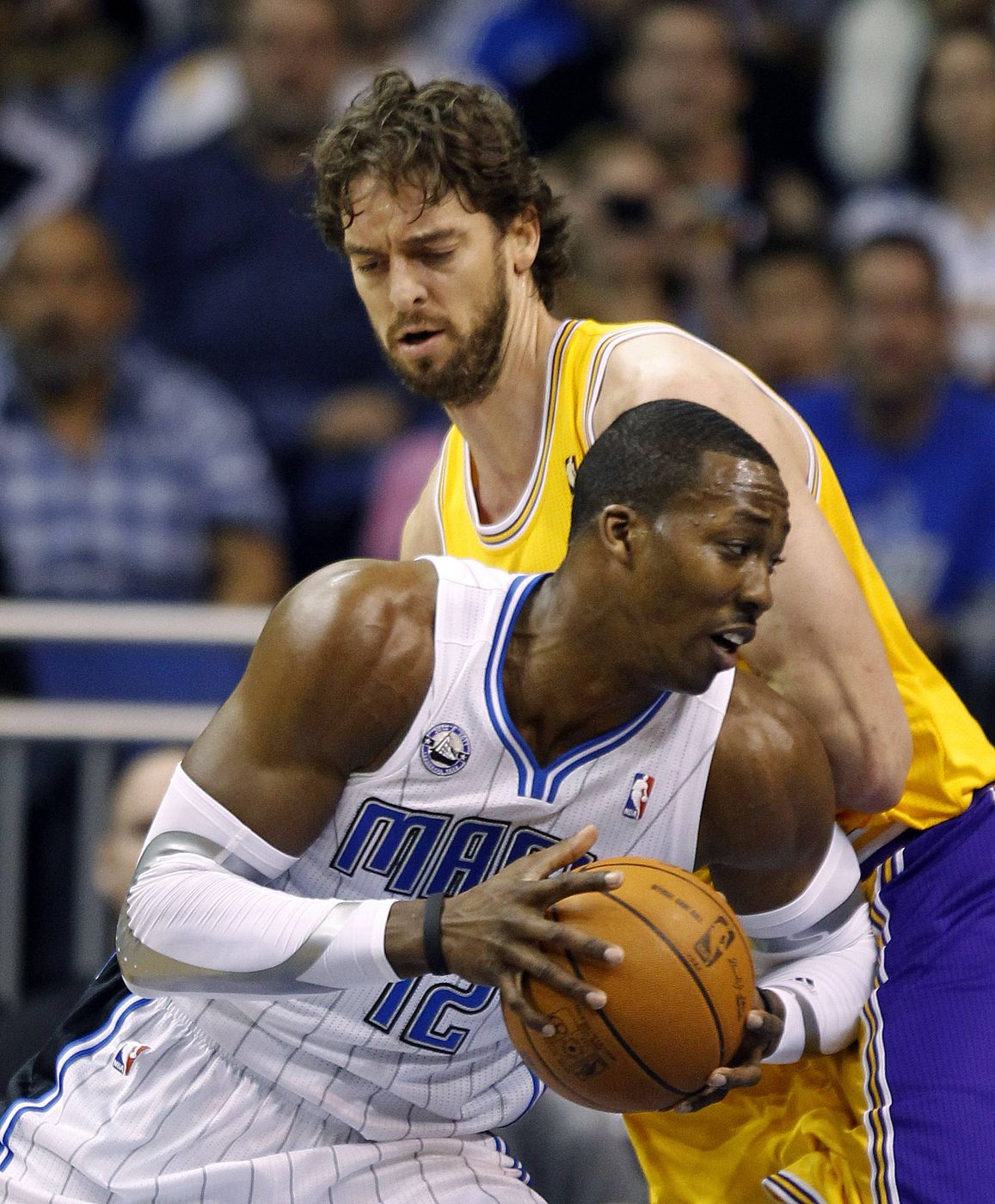 Magic's Howard drives against Lakers' Gasol during first half NBA basketball action in Orlando