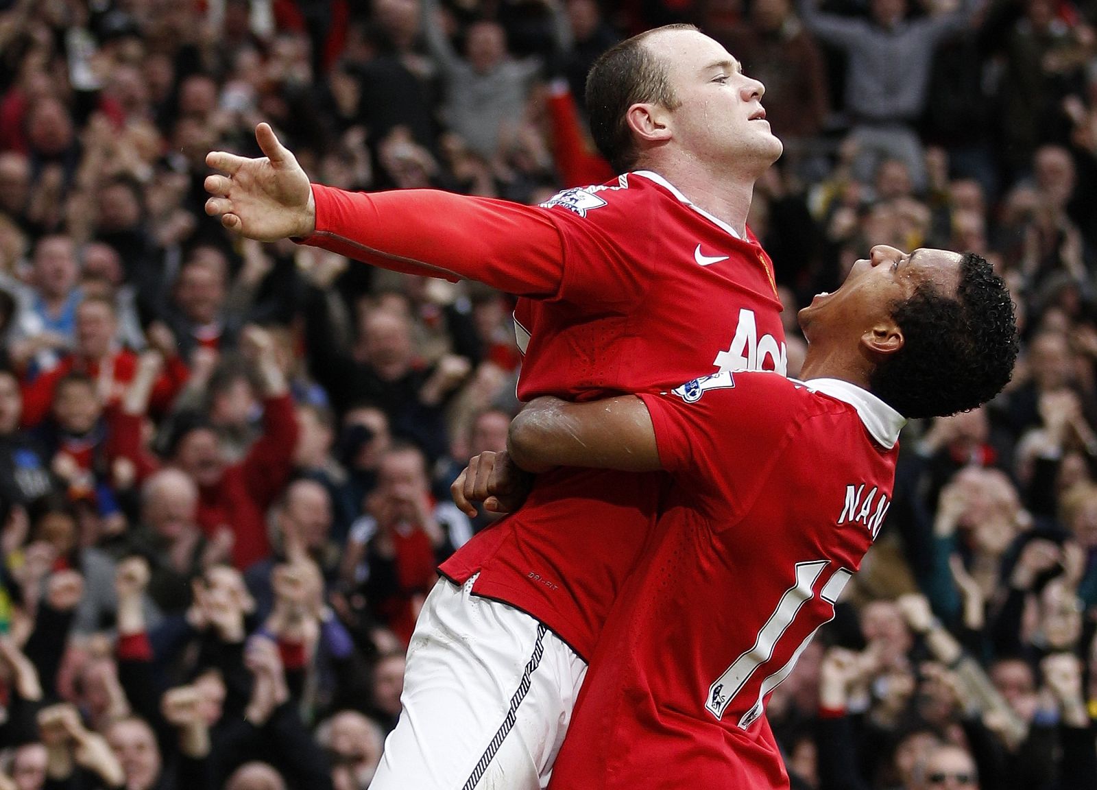 Manchester United's Wayne Rooney celebrates scoring against Manchester City with team mate Nani during their English Premier League soccer match at Old Trafford in Manchester