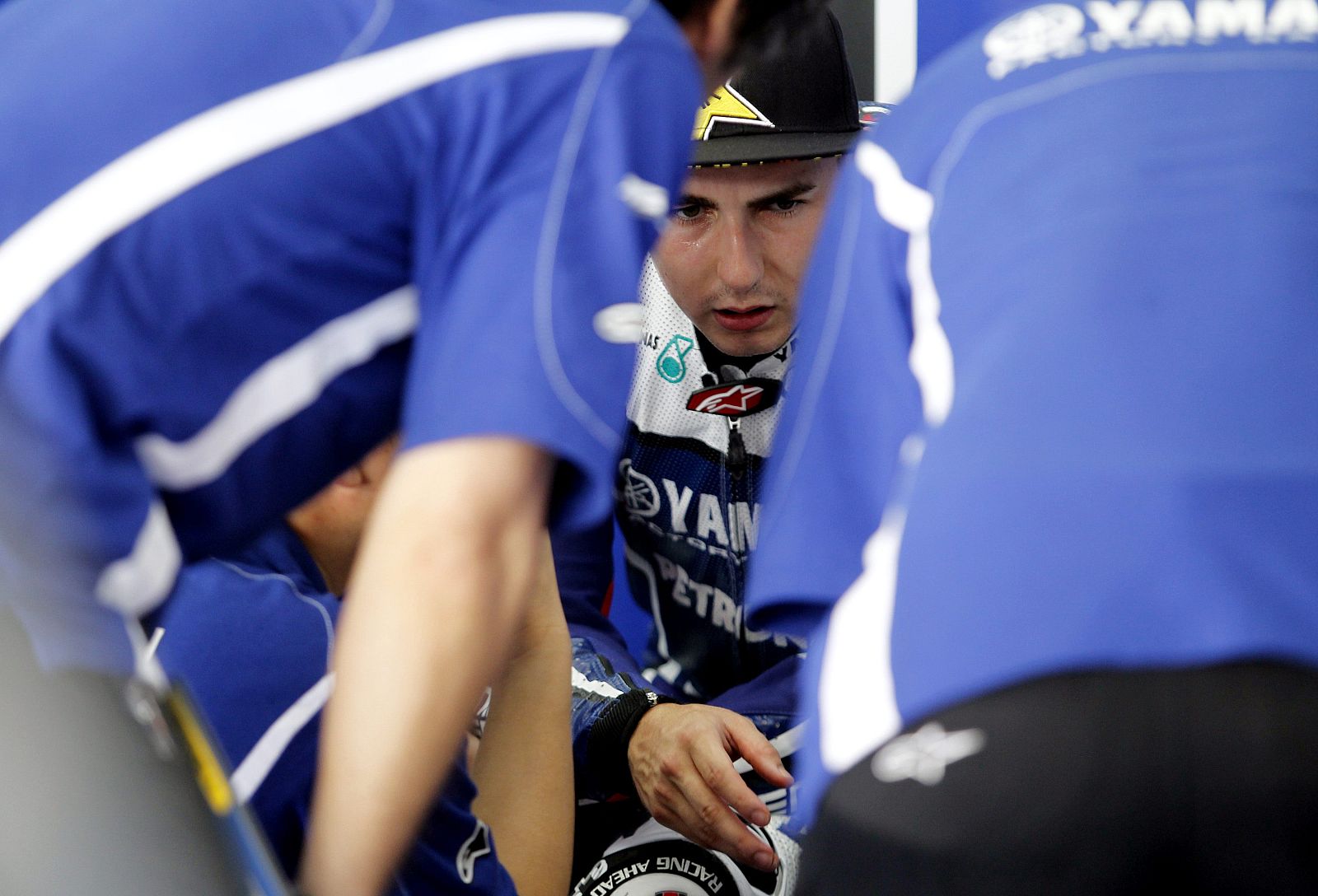 Yamaha MotoGP rider Jorge Lorenzo of Spain talks to crew at pit during test session in Sepang