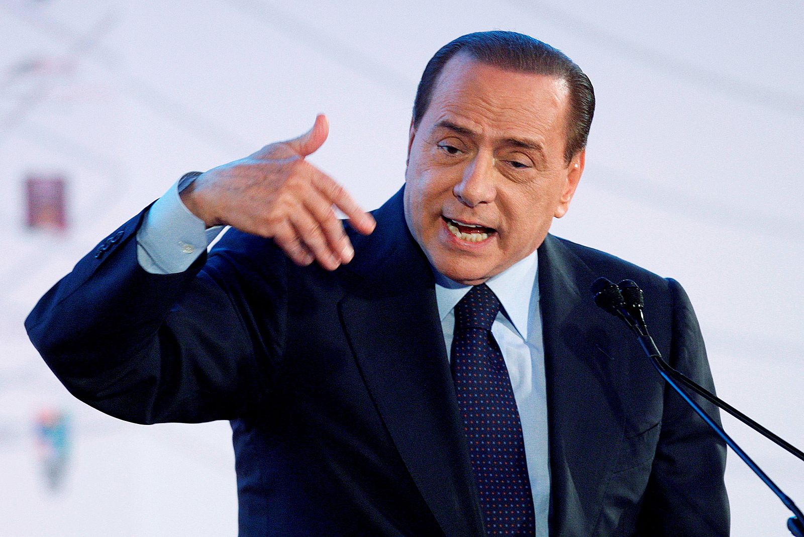 Italian Prime Minister Silvio Berlusconi gestures as he delivers his speech during a two-day event in Rome