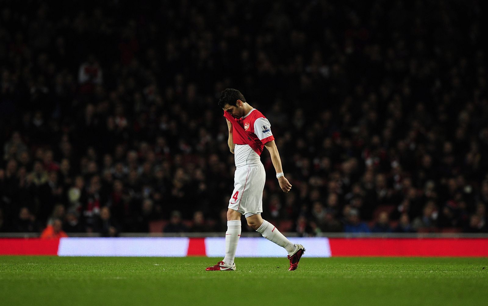 Arsenal's captain Cesc Fabregas walks off the pitch as he is substitued during their English Premier League soccer match against Stoke City in London