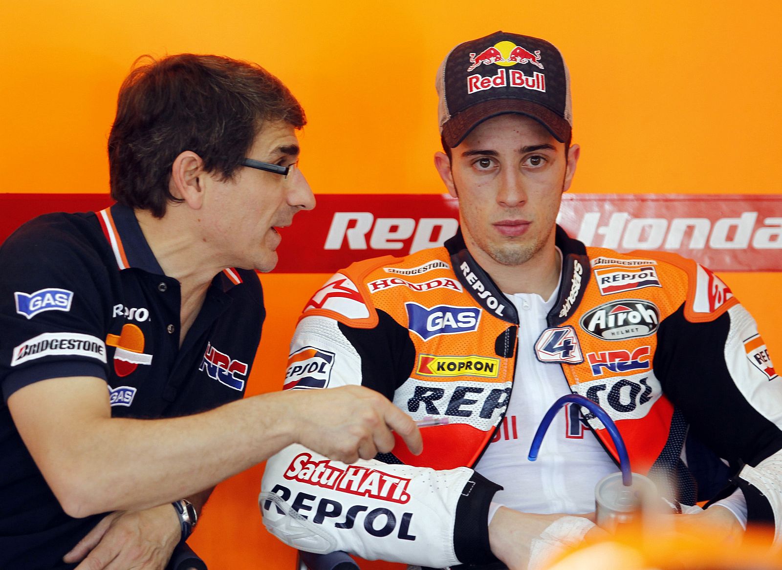 Honda MotoGP rider Andrea Dovizioso of Italy listens to his mechanic during test session in Sepang
