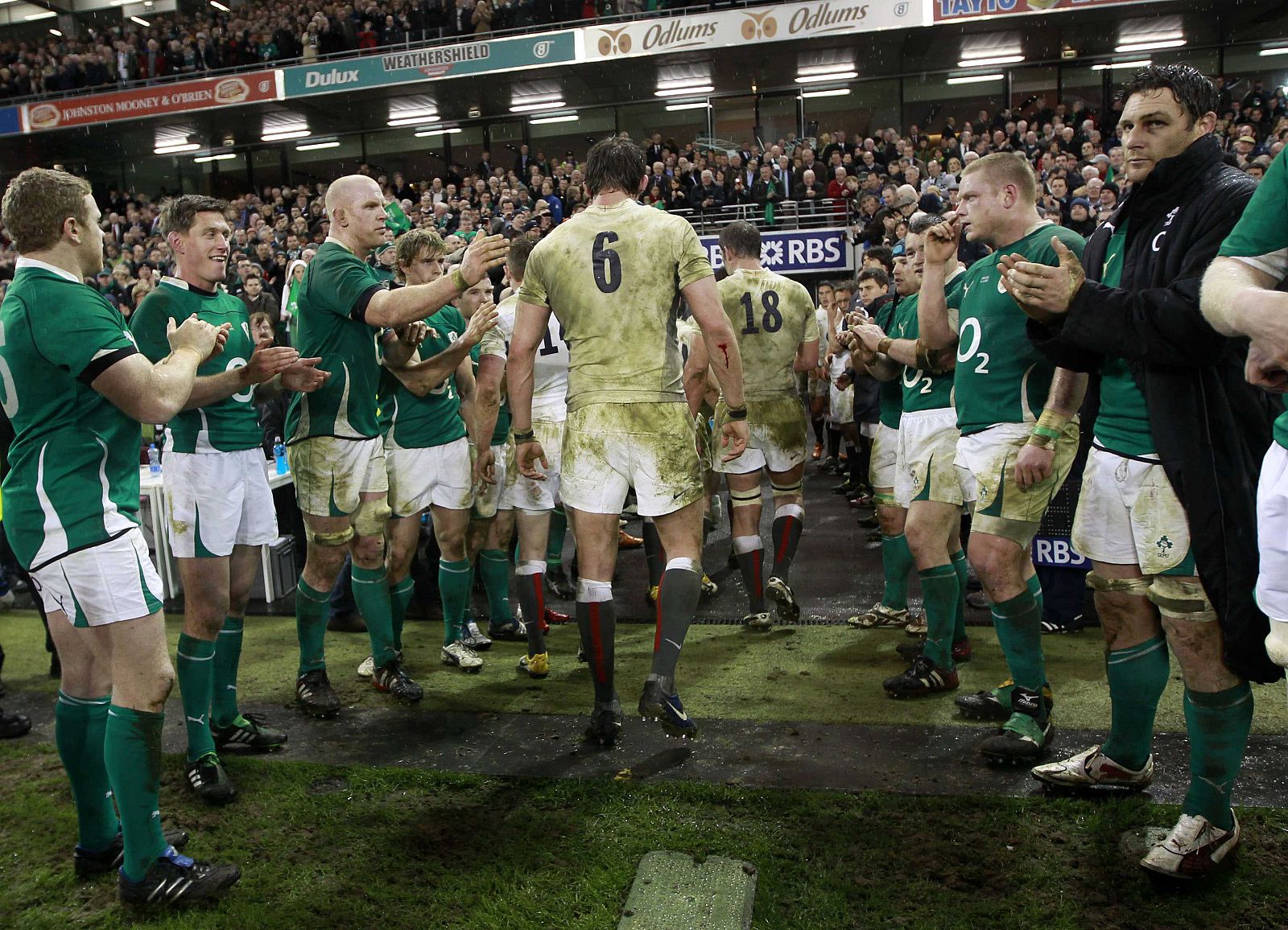 The England players are applauded off the pitch by the Ireland players after their Six Nations rugby union match in Dublin