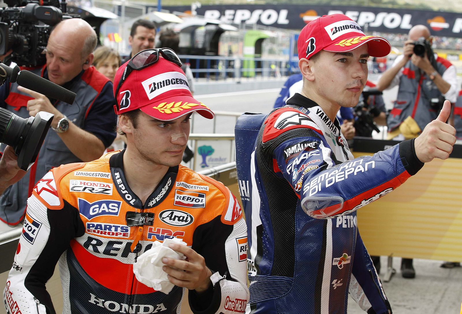 Yamaha MotoGP rider Lorenzo of Spain gestures next to Honda's rider Pedrosa of Spain after the qualifying practice session of the Spanish Grand Prix in Jerez