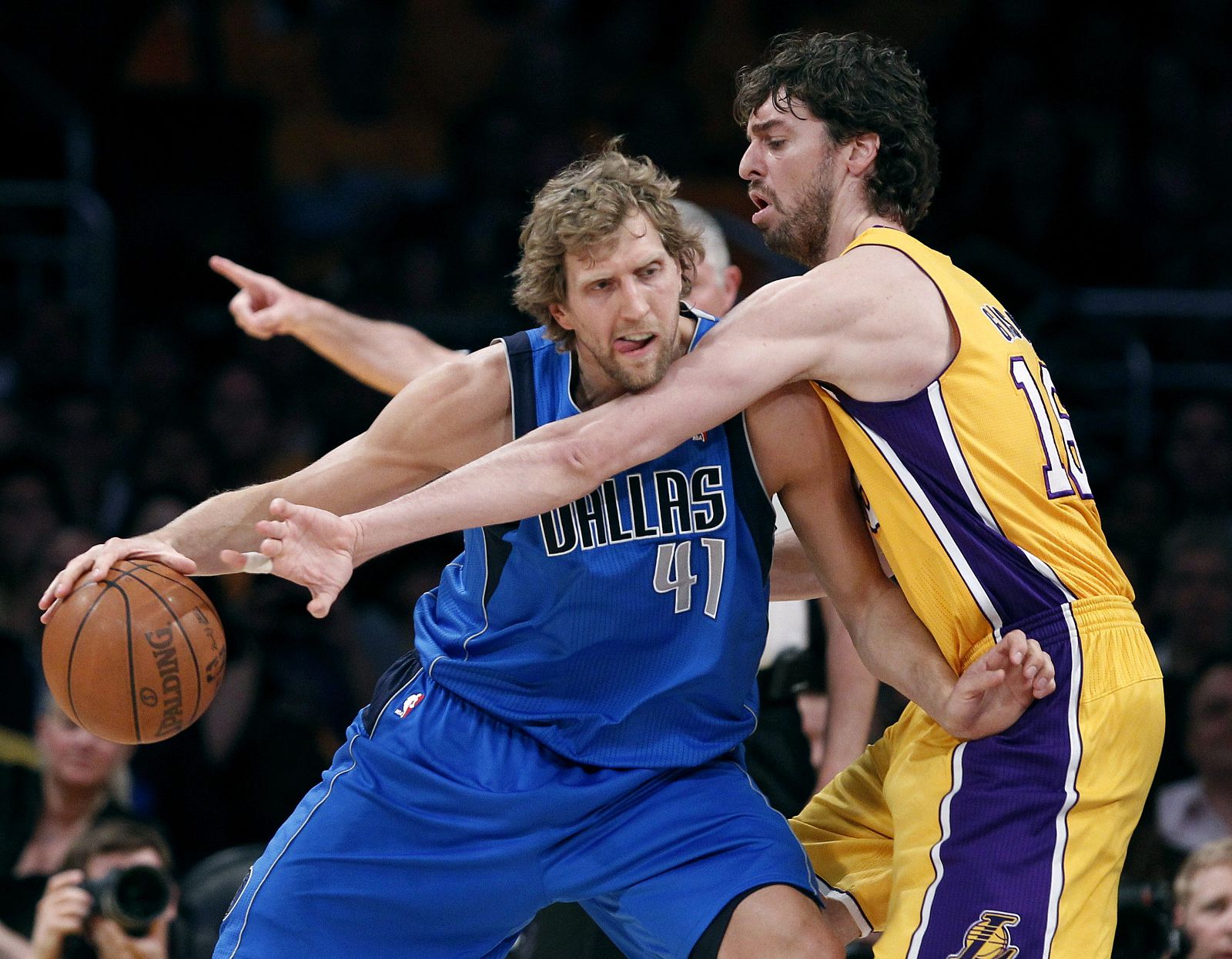 Dallas Mavericks power forward Dirk Nowitzki moves in on Los Angeles Lakers power forward Pau Gasol in the first quarter during Game 1 of their NBA Western Conference semi-final basketball playoff in Los Angeles