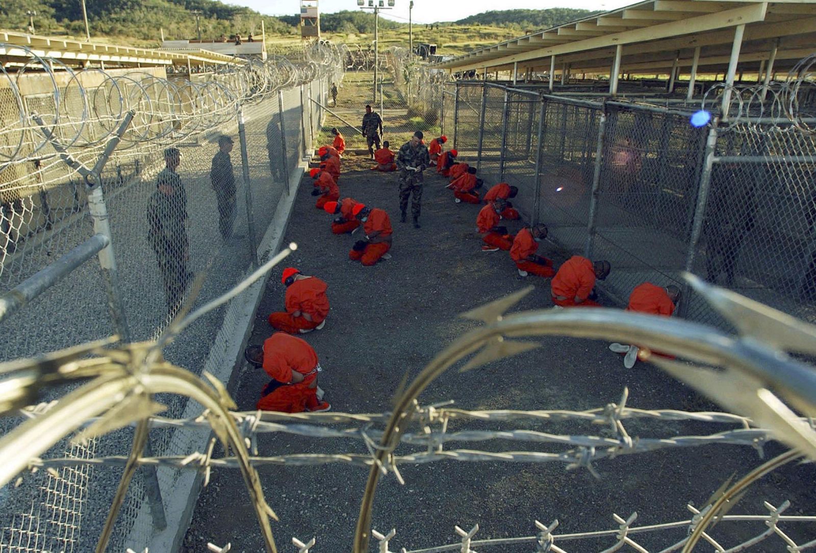File photo of detainees sitting in a holding area at Naval Base Guantanamo Bay
