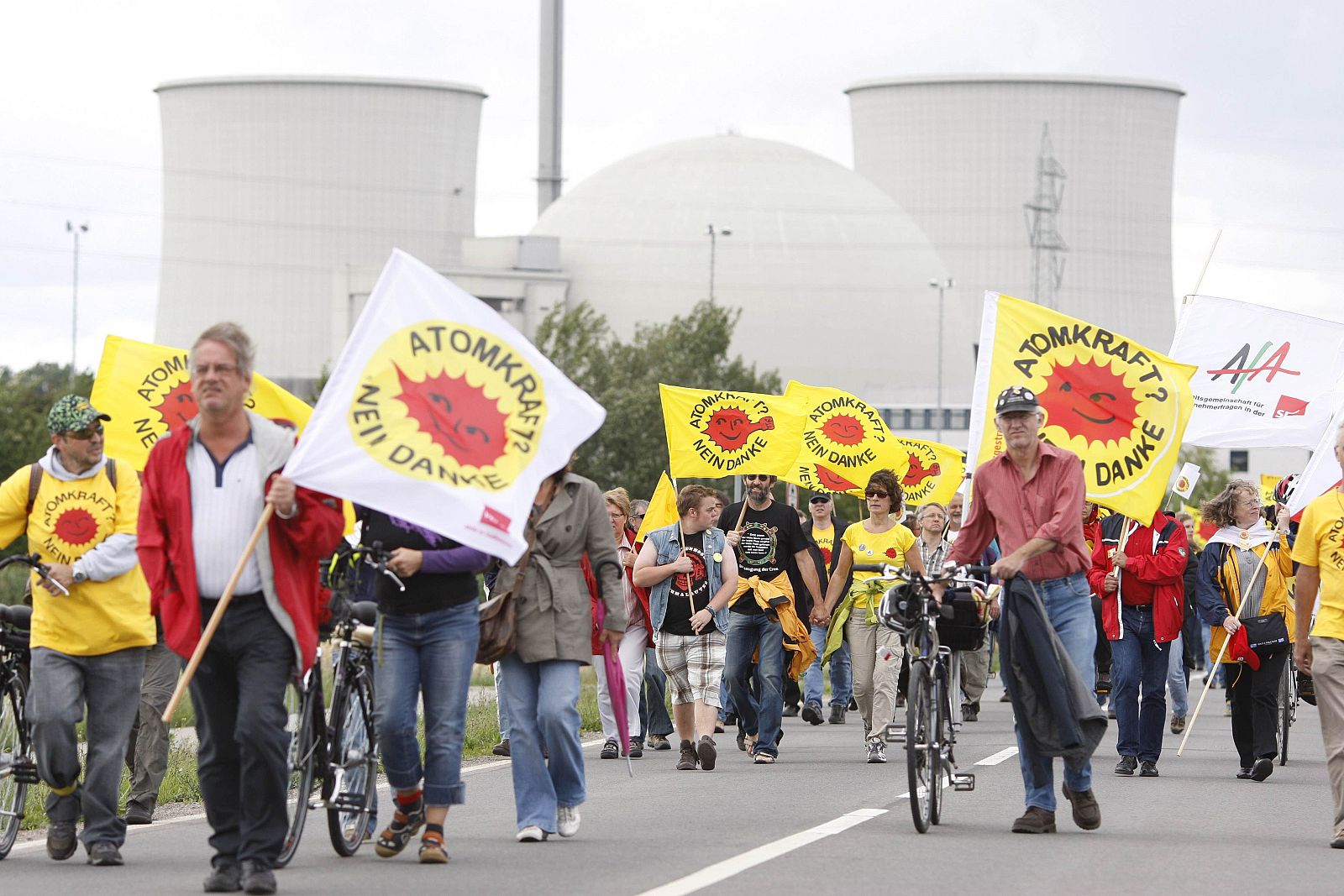 Protestors walk along the Biblis nuclear power plant during a demonstration in Biblis