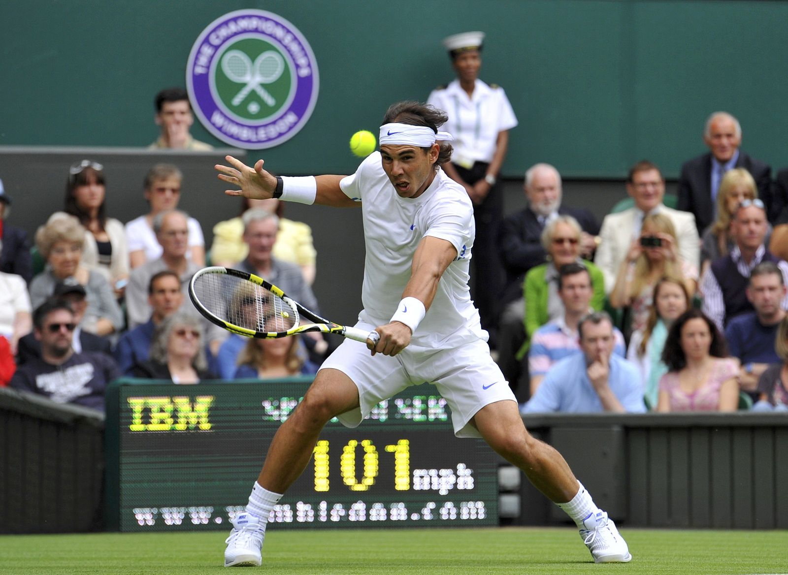 Rafael Nadal of Spain hits a return to Michael Russell of the U.S. at the 2011 Wimbledon tennis championships in London