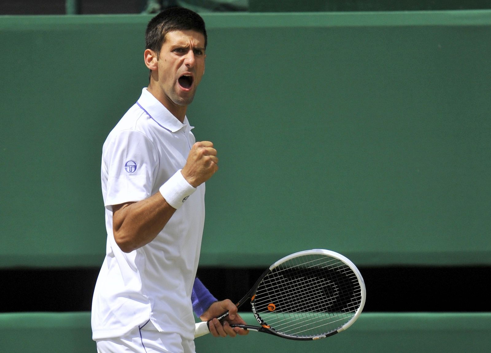 Novak Djokovic of Serbia reacts during his semi-final match against Jo-Wilfried Tsonga of France at the Wimbledon tennis championships in London