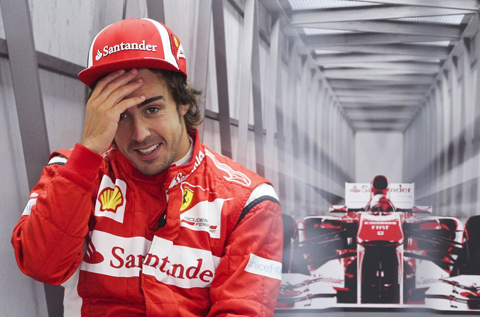 Ferrari Formula One driver Alonso of Spain sits in his pit during a practice session of the German F1 Grand Prix at the Nuerburgring circuit
