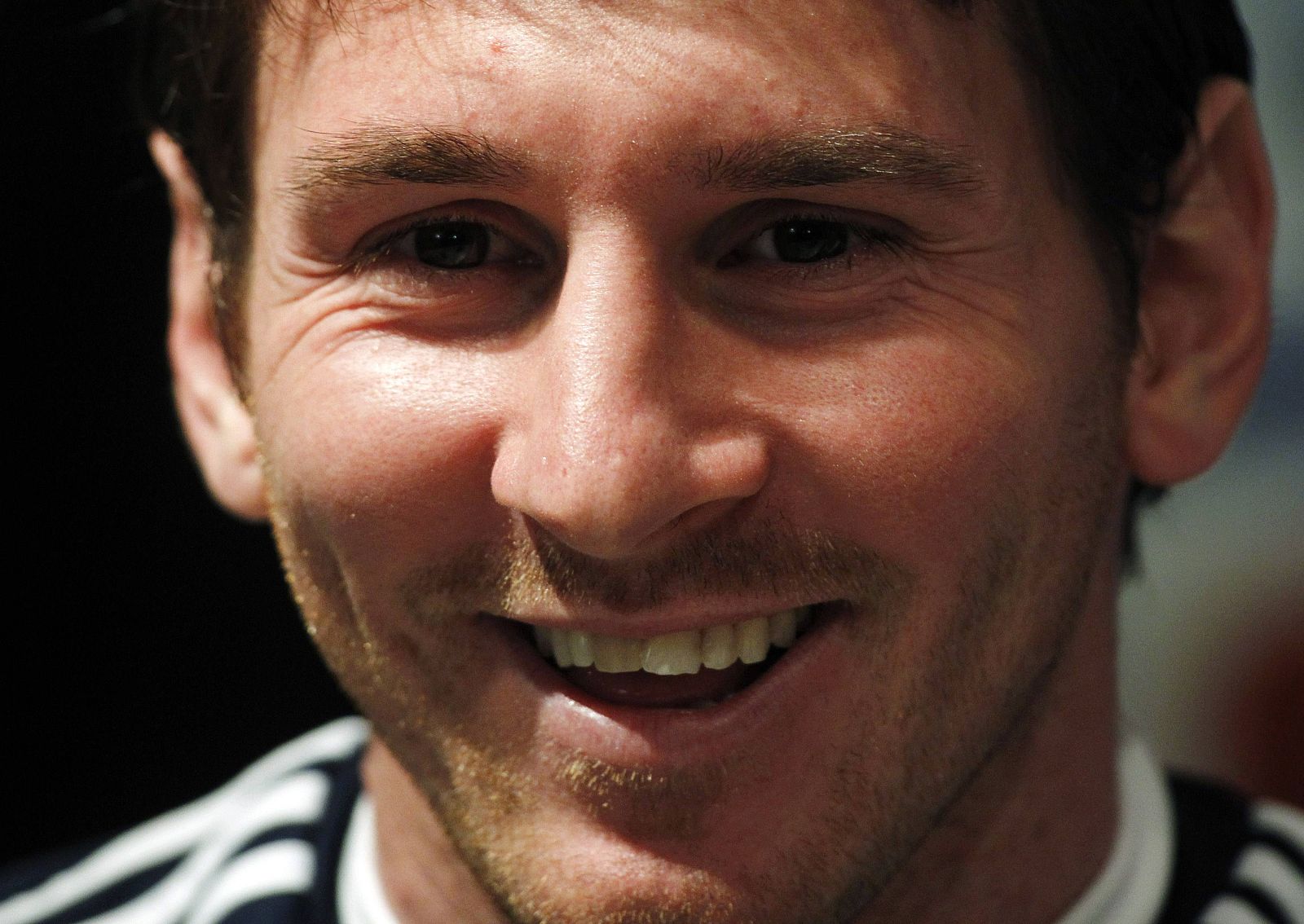 Argentina's national soccer player Messi smiles during a news conference at the squad's headquarters in Buenos Aires