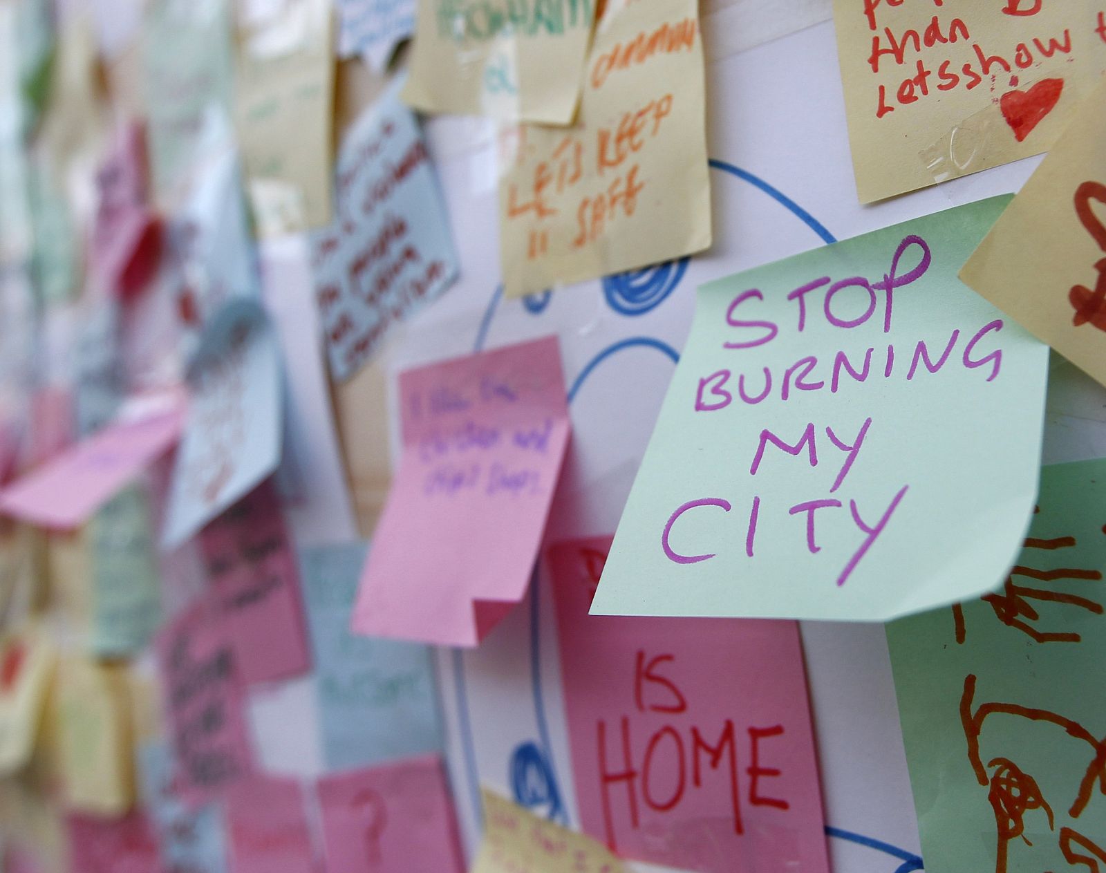 Hundreds of messages of support from the community of Peckham are seen posted on a looted storefront in south London