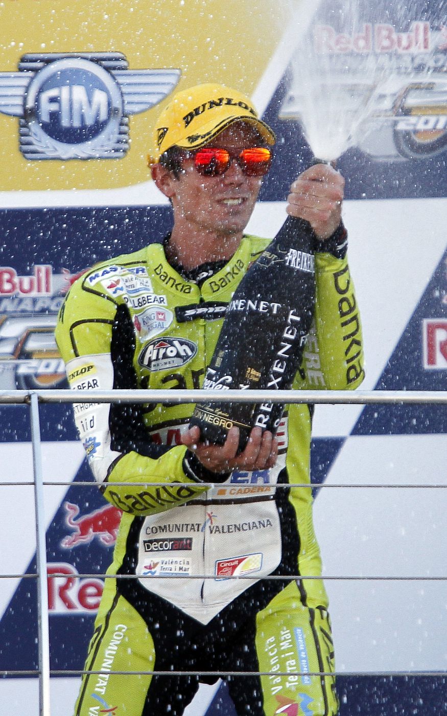 Aprilia 125cc class rider Nicolas Terol of Spain sprays champagne from the podium after winning 125cc class race prior to Indianapolis Grand Prix MotoGP race in Indianapolis